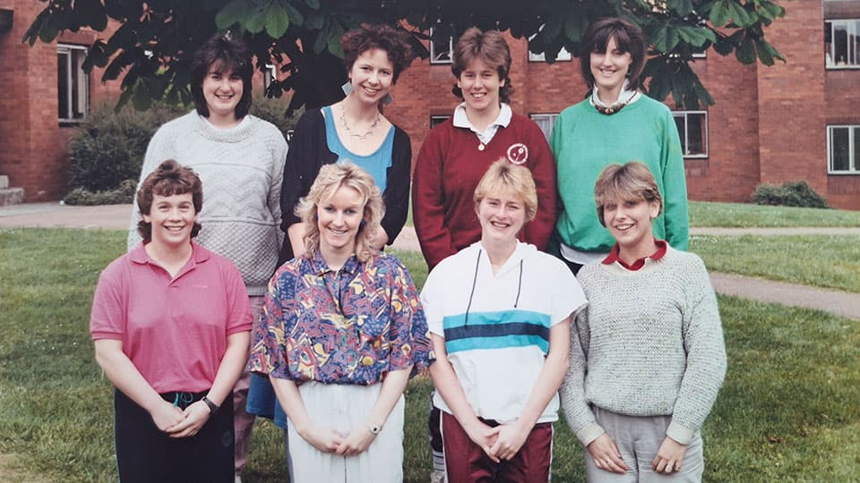 Eight women during Summer 1986 post exams. The group are standing together and smiling.